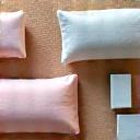 Comfortable yoga bolsters, blankets, and blocks arranged for deep relaxation in a restorative yoga class.